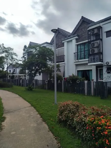 Exterior type: linked terrace house; features: two-storey building, brick facade, balconies with black railings, gabled roof, manicured lawn, flower beds with shrubs and flowers, pathway leading to the house, street lamp, surrounding greenery; style: modern.
