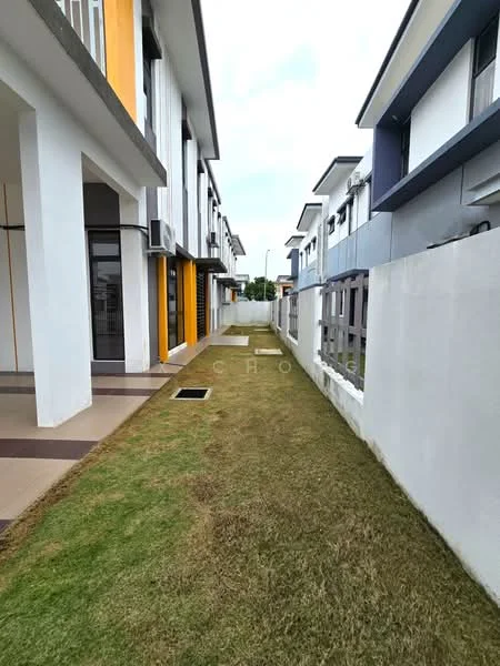 Exterior type: linked terrace house; features: manicured lawn, concrete walkway, two-storey building, white painted facade, grey painted facade, yellow accent wall, air conditioning units visible, fenced perimeter, side yard space, adjacent buildings, clear sky; style: modern.