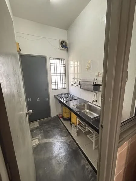 Kitchen features: black countertop, stainless-steel sink, chrome faucet, 2-burner gas hob, white tiled walls, grey painted door, window with metal grille, open shelving, yellow storage containers, concrete flooring.