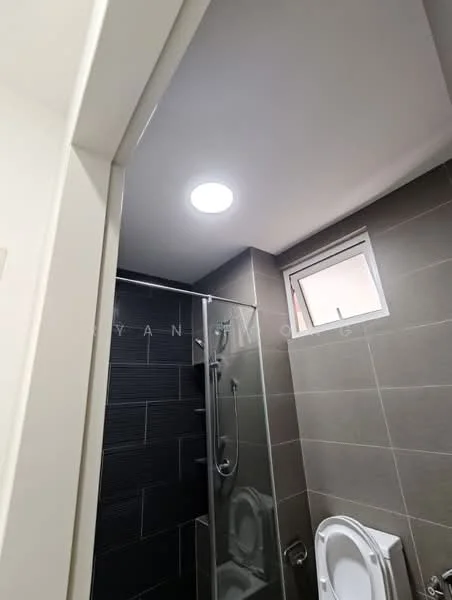 Bathroom features: shower with glass enclosure, chrome handheld shower, white toilet, grey tiled walls, white ceiling with recessed lighting, small window, grey floor tiles, chrome faucet; style: modern.