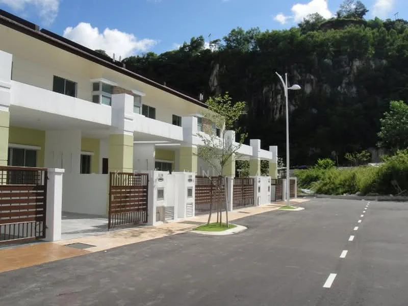 Exterior type: linked terrace house; features: two-storey building, white painted facade, green accent walls, gated entrance, paved driveway, landscaped garden area, street lighting, surrounded by greenery, concrete fencing, parking space; style: modern.