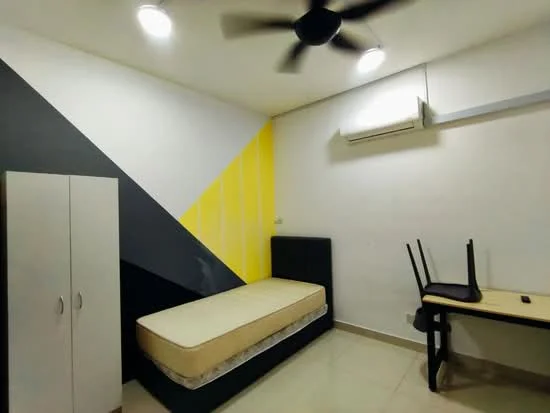 Bedroom features: single bed, black bed frame, white painted walls, accent wall with yellow and black geometric pattern, ceiling fan, wall-mounted air conditioning unit, light-colored tile flooring, wooden study desk, chair, wardrobe with two doors; style: modern.