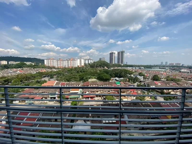 Exterior type: high-rise condominium; features: city skyline view, surrounded by residential buildings, greenery in the foreground, multiple high-rise buildings in the background, clear blue sky with scattered clouds, balcony railing visible; style: modern.