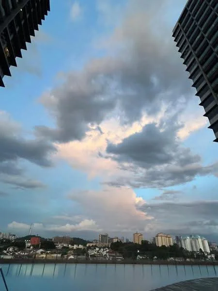 Exterior features: city skyline, cloudy sky, water reflection, high-rise buildings in background, urban landscape; style: modern.