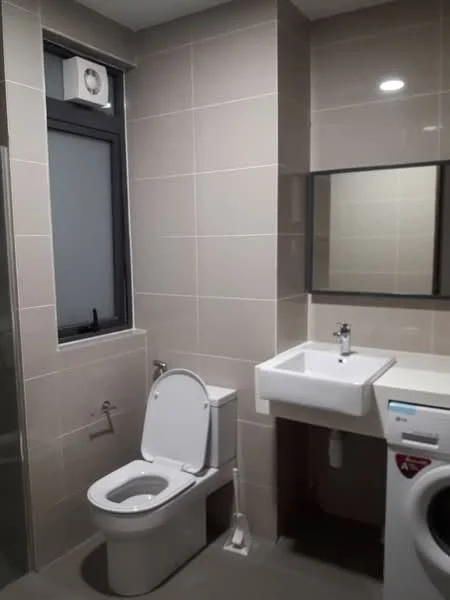 Bathroom features: white ceramic toilet, single-sink vanity with wall-mounted faucet, mirror above sink, built-in washing machine, grey tiled flooring, beige tiled walls, window with black frame, recessed LED downlights, wall-mounted ventilation unit; style: modern.
