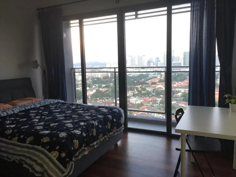 Bedroom features: king-size bed with patterned bedding, floor-to-ceiling windows, curtains in dark blue, wooden flooring, desk with white surface, black chair, decorative plant on desk, city skyline view; style: modern; view: city.