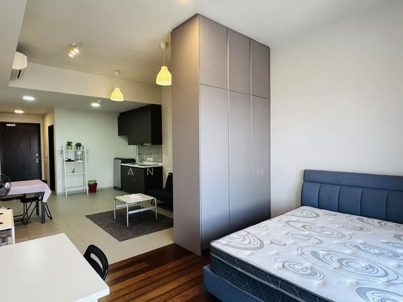 Room features: queen-size bed, upholstered headboard, wood flooring, grey built-in wardrobe, recessed downlights, pendant lighting, open-plan layout, kitchenette with black cabinetry, white countertop, grey mosaic tile backsplash, living area with sofa, area rug, dining table for two, wall-mounted TV; style: modern.