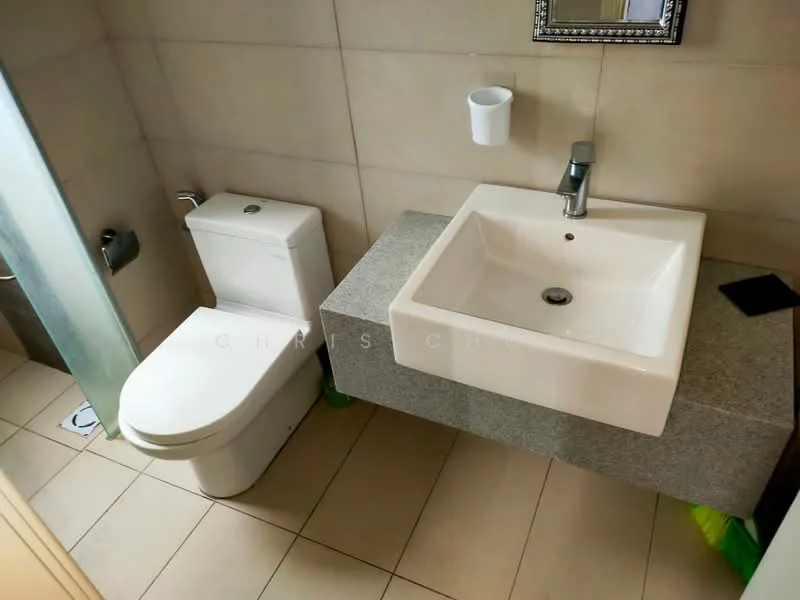 Bathroom features: white wall tiles, grey granite countertop, square ceramic sink, chrome basin mixer faucet, one-piece toilet, glass shower enclosure, tile flooring, mirror with decorative frame; style: modern.