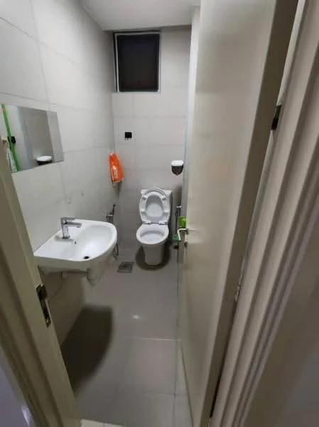Bathroom features: white tiled walls, grey tiled flooring, single-sink vanity with wall-mounted faucet, one-piece toilet, framed mirror above sink, window for natural light, hand towel holder, soap dispenser, orange hand towel, toilet paper holder; style: modern.