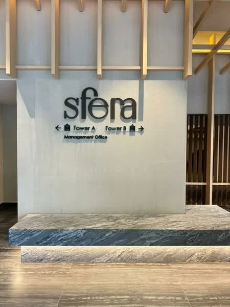 Room features: reception desk, signage with directional arrows, wooden ceiling beams, stone countertop, textured wall panel, grey tiled flooring, ambient lighting, modern design elements; style: modern.