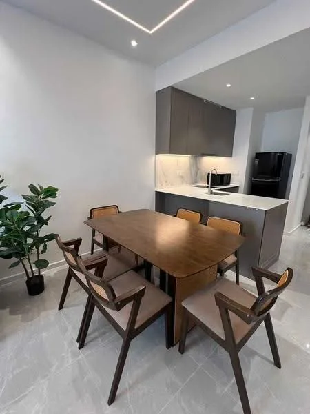 Dining features: wooden dining table, 4 wooden dining chairs with fabric seats, white marble countertop, grey cabinetry, recessed ceiling lights, light grey tile flooring, indoor plant in pot, black refrigerator visible in background; style: modern.