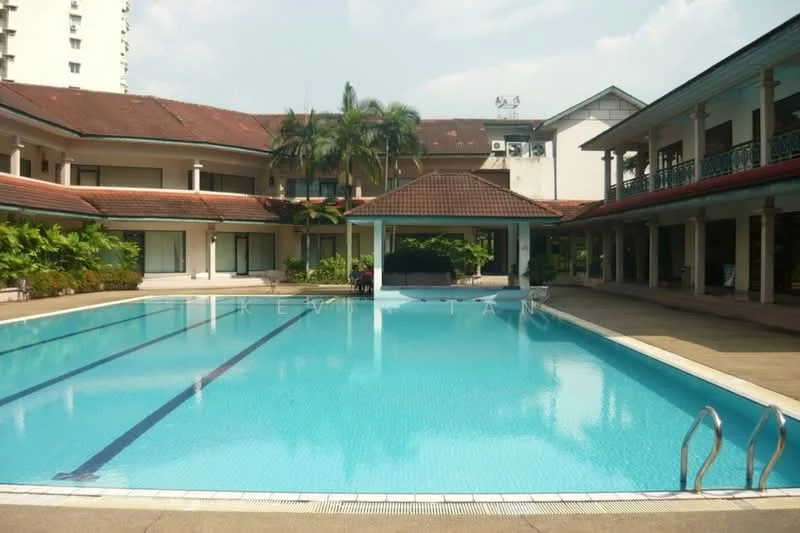 Exterior type: clubhouse; features: swimming pool, pool deck with loungers, surrounded by tropical landscaping, palm trees, manicured lawn, covered pavilion, two-storey building, sliding glass doors, terracotta roof, outdoor seating area; style: tropical-modern.