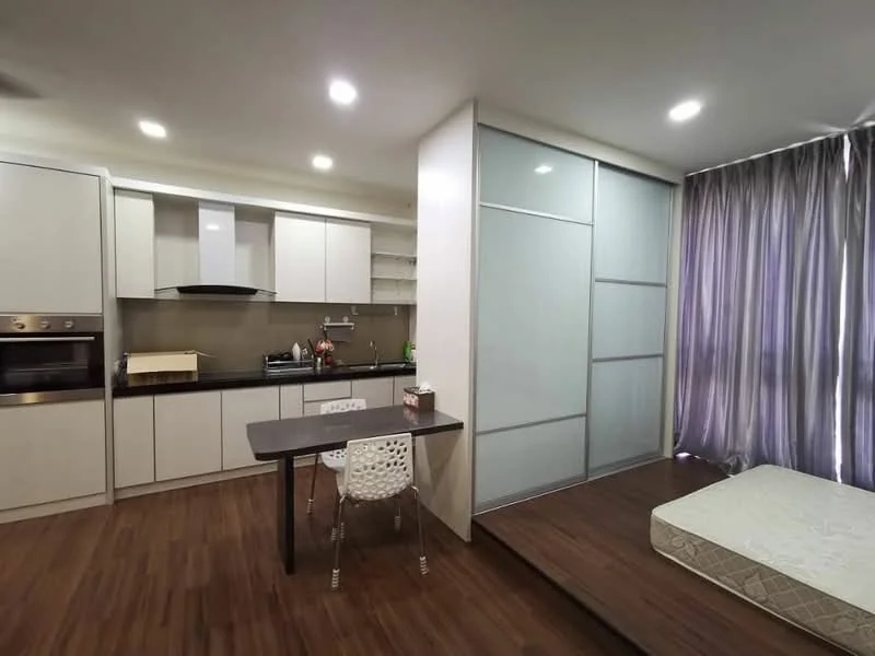 Kitchen features: white cabinetry, stainless-steel built-in oven, stainless-steel range hood, 4-burner gas hob, single-bowl stainless-steel sink, chrome pull-down faucet, grey countertop, open shelving, wooden flooring, recessed downlights; style: modern. Living features: dining table with white chair, mattress on platform bed, floor-to-ceiling windows with sheer curtains, wooden flooring, recessed downlights; style: modern.
