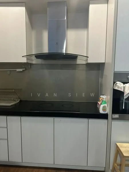 Kitchen features: white cabinetry, black countertop, stainless-steel range hood, glass backsplash, induction cooktop, dish rack, cleaning supplies on countertop, wooden stool; style: modern.