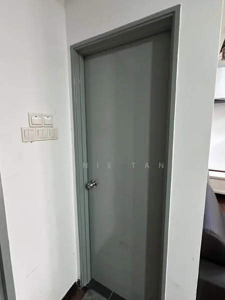Room features: grey door, metal door handle, white walls, light grey trim, light switch panel with multiple switches, dark flooring; style: modern.