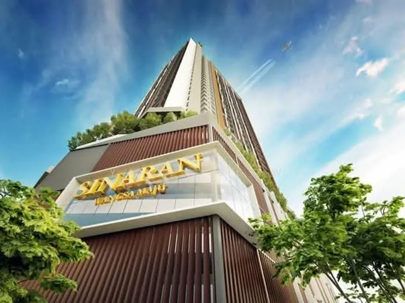Exterior type: high-rise condominium; features: glass curtain wall, wooden cladding, greenery on balconies, signage with the name 'Sinaran', modern architectural design, multiple storeys, skyline view, surrounded by trees, clear blue sky; style: modern.