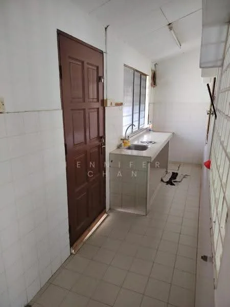 Kitchen features: white tiled walls, light grey tiled flooring, single-bowl stainless-steel sink, chrome pull-down faucet, wooden cabinet door, window with metal grille, countertop, door leading to another room.
