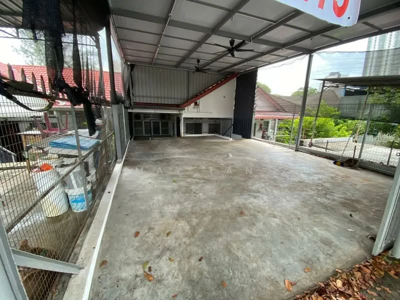 Exterior features: concrete flooring, metal roof, open space, surrounded by fencing, partial wall structure, visible greenery outside, large open area, no visible windows or doors; style: modern.