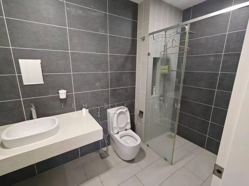 Bathroom features: grey tiled walls, white countertop with integrated sink, single-bowl sink, chrome basin mixer faucet, glass shower enclosure, handheld shower, toilet, wall-mounted toilet roll holder, tile flooring, mirror, shower caddy; style: modern.