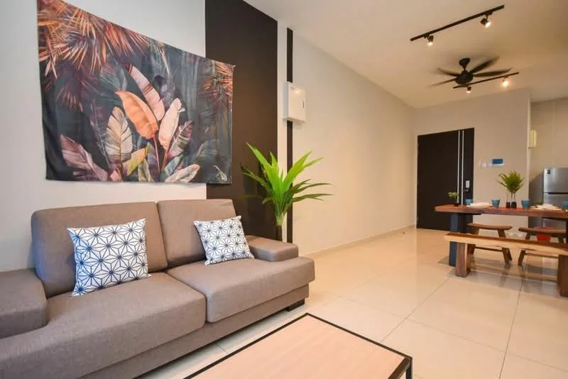 Living features: 3-seater fabric sofa in grey, decorative cushions with geometric pattern, coffee table, wall-mounted air conditioning unit, ceiling fan with light, wall art with tropical leaves, large potted plant, tile flooring, neutral painted walls, recessed lighting; style: modern. Dining features: wooden dining table, benches for seating, decorative plant on table, open layout to living area; style: modern.