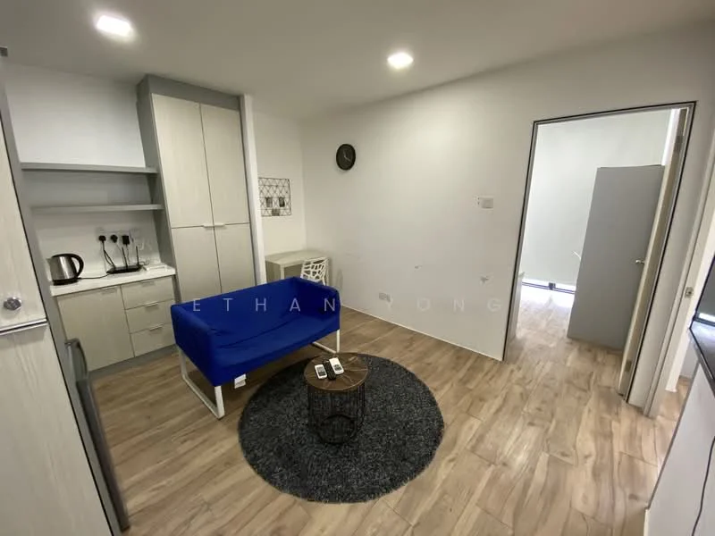 Living features: blue fabric sofa, round coffee table, area rug with circular pattern, light wood flooring, white painted walls, recessed LED downlights, built-in cabinetry, kettle, microwave, fridge; style: modern.