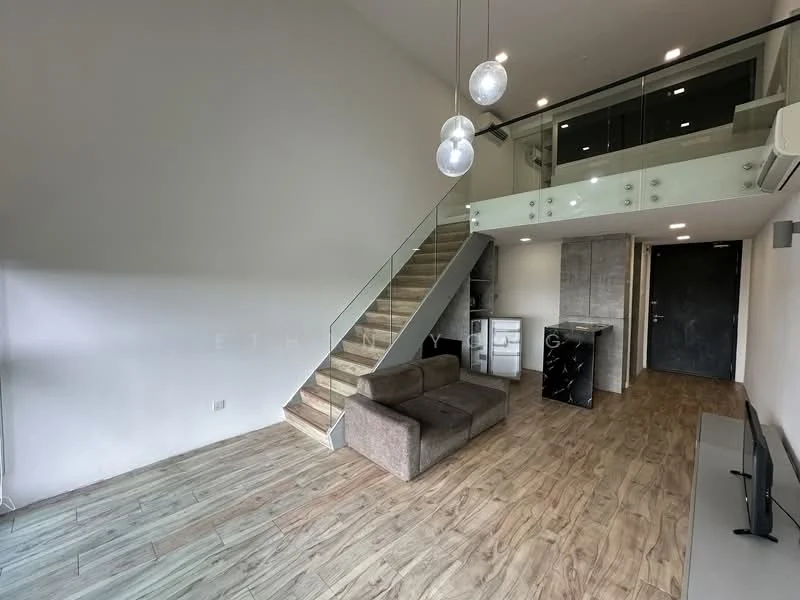 Living features: wooden flooring, grey fabric sofa, wall-mounted TV, recessed downlights, glass railing, staircase with wooden steps, air conditioning unit, open layout, kitchenette area with cabinets, black fridge, neutral wall colour; style: modern.