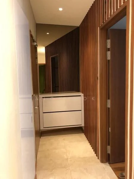 Hallway features: wood paneling on one wall, white painted walls, recessed ceiling lights, stone tile flooring, built-in white cabinet with drawers, wooden door, mirror reflecting light, narrow corridor layout; style: modern.