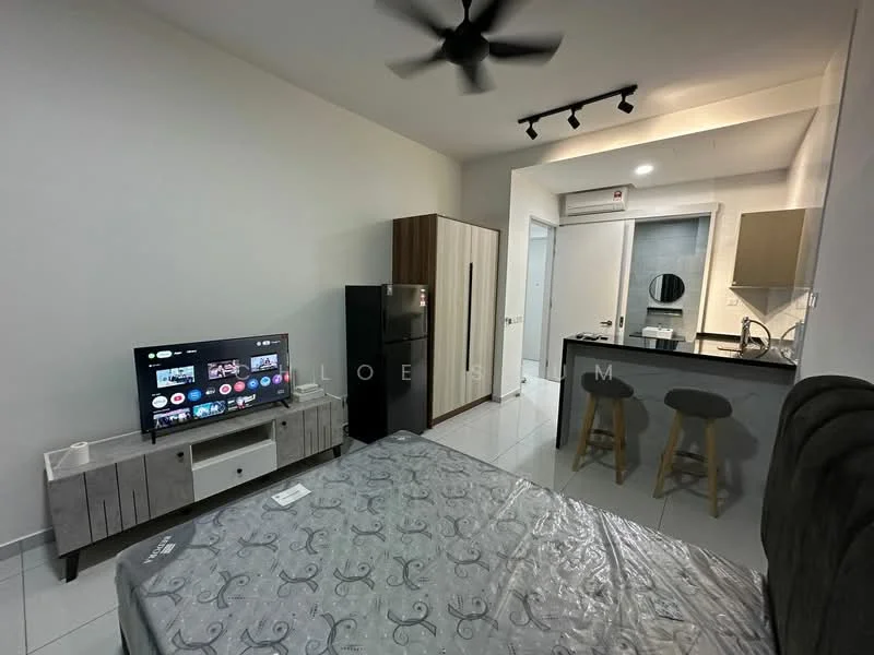 Living features: queen-size bed with grey bedding, 3-blade ceiling fan, wall-mounted TV, TV console in white with wood accents, refrigerator in black, kitchenette with countertop, bar stools, white tiled flooring, light grey painted walls, air conditioning unit, kitchen sink, cabinets above the countertop; style: modern.