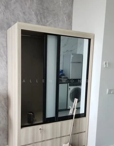 Room features: built-in wardrobe with sliding glass doors, wooden cabinetry with light wood finish, laundry machine visible in background, grey accent wall, white wall, flooring not visible; style: modern.