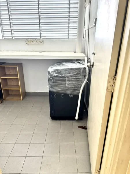 Laundry features: washing machine wrapped in plastic, grey cabinet, tile flooring, window with horizontal slats, white walls, door, shelving unit.