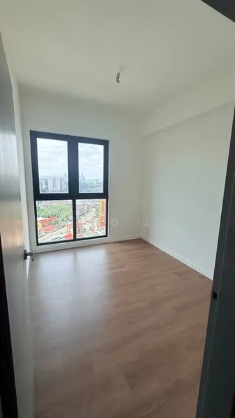 Room features: light wood laminate flooring, white painted walls, floor-to-ceiling windows, black window frames, city view, single ceiling light fixture; style: modern; view: city.