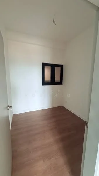 Room features: white painted walls, laminate flooring, window with black frame, single light fixture on ceiling, door with handle.