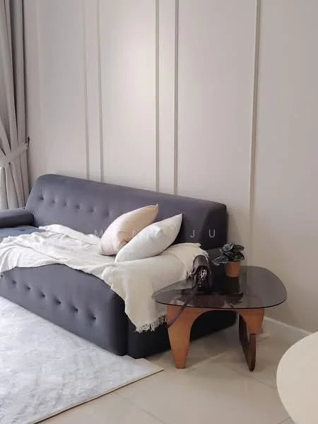 Living features: grey fabric sofa with tufted design, decorative throw pillows in beige and cream, light-colored area rug, wooden side table with curved legs, small potted plant on side table, light-colored wall with paneling, floor-to-ceiling curtains, neutral-colored walls; style: modern.
