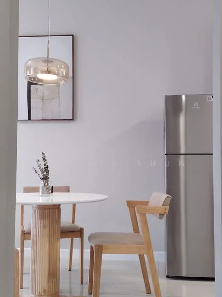 Dining features: round white dining table, wooden dining chairs, stainless-steel fridge, pendant light fixture, grey painted walls, framed artwork on wall, wooden table base, ceramic vase with dried flowers, polished tile flooring; style: modern.