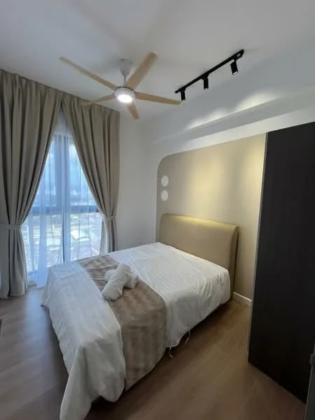 Bedroom features: queen-size bed with upholstered headboard, white bedding, wooden flooring, 5-blade ceiling fan with light, floor-to-ceiling windows, sheer curtains, dark wood wardrobe, accent wall with light beige paint, track lighting; style: modern; view: garden.