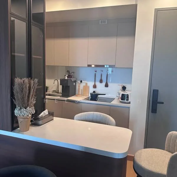 Kitchen features: light grey cabinetry, white countertop, stainless-steel sink, chrome pull-down faucet, built-in microwave, freestanding range oven, coffee machine, wooden utensils on wall, bar stools, decorative plant in pot, kitchen island; style: modern.