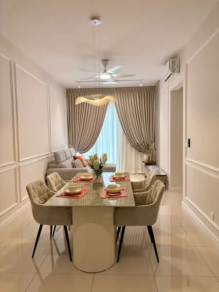 Dining features: rectangular dining table with white surface, 4 upholstered dining chairs in light grey, decorative vase with flowers on table, chandelier light fixture, 5-blade ceiling fan, cream painted walls with wainscoting, large window with sheer curtains, light-coloured tiled flooring, sofa in light grey against wall, wall-mounted air conditioning unit; style: modern.
