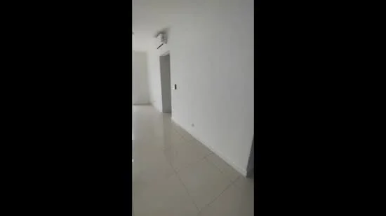 Room features: white painted walls, glossy tile flooring, wall-mounted split AC, doorway, light fixture on ceiling.