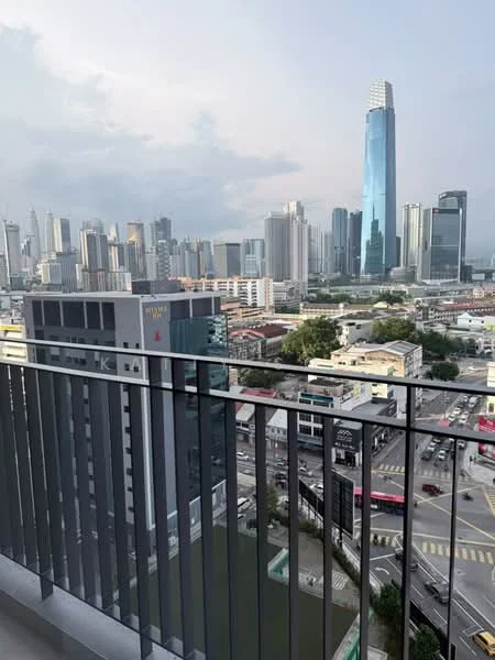 Exterior type: high-rise condominium; features: city skyline view, glass curtain wall, balcony railing, surrounding urban landscape, adjacent roadways, nearby commercial buildings; style: modern.