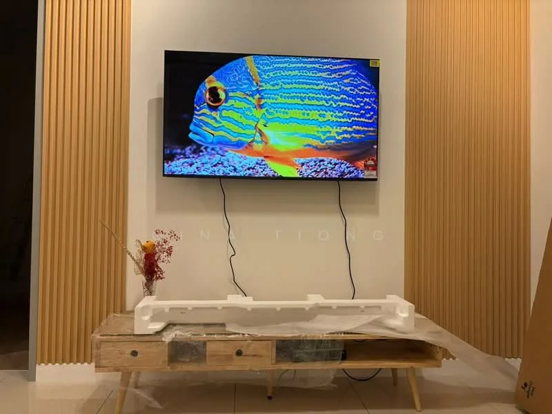 Living features: wall-mounted TV, wooden TV console, decorative fish artwork on screen, decorative vase with flowers, striped wall paneling, cream painted walls, tile flooring, plastic covering on furniture; style: modern.