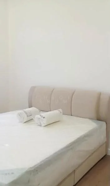 Bedroom features: queen-size bed, upholstered headboard, light-colored bedding, two rolled towels, light wood flooring, white painted walls, natural light from window, minimalist decor; style: modern.