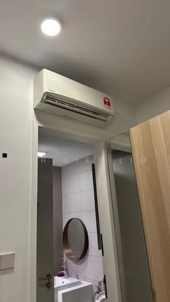 Room features: wall-mounted split AC, white painted walls, light fixture on ceiling, wooden door, round mirror, white toilet, grey tiled flooring; style: modern.