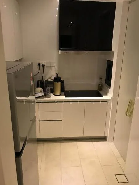 Kitchen features: white cabinetry with flat-panel doors, black countertop, stainless-steel fridge, built-in oven, stainless-steel range hood, single-bowl stainless-steel sink, chrome pull-down faucet, tile flooring, wall-mounted electrical outlets, under-cabinet lighting, kitchen appliances including kettle and coffee machine; style: modern.