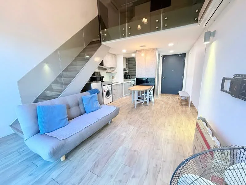 Living features: grey fabric sofa, two blue throw pillows, wooden dining table, white wooden chairs, built-in washing machine, kitchen cabinetry, recessed downlights, laminate flooring, staircase with glass railing, air conditioning unit, wall-mounted TV, open layout; style: modern.