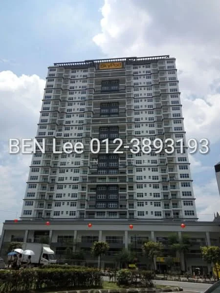 Exterior type: high-rise condominium; features: glass curtain wall, white painted facade, recessed balconies, multiple storeys, commercial space at ground level, landscaped area with palm trees, outdoor seating area, signage on building, parking area visible, urban context with surrounding buildings; style: modern.