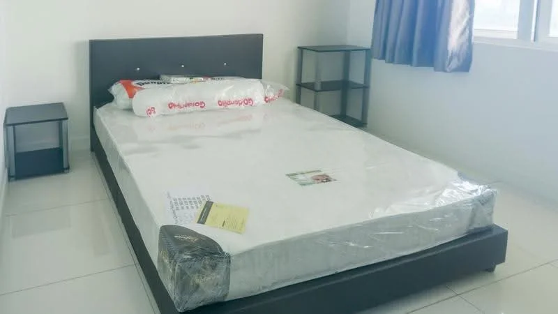 Bedroom features: queen-size bed, mattress with plastic covering, dark wood bed frame, two bedside tables, white walls, large window with grey curtains, glossy tile flooring, decorative wall art, bedside lamp; style: modern.