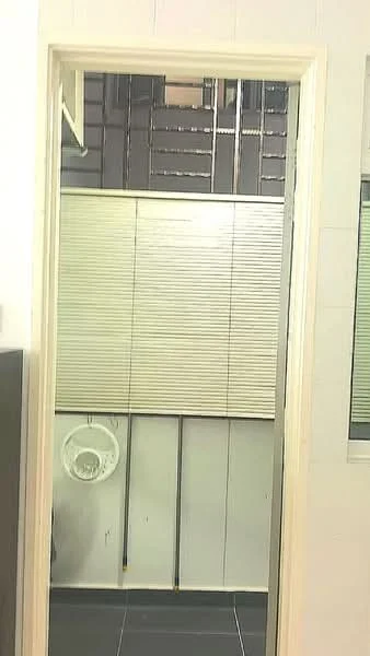 Bathroom features: white tiled walls, black tile flooring, toilet, blinds on window, exposed plumbing, mirror, light fixture, door frame.