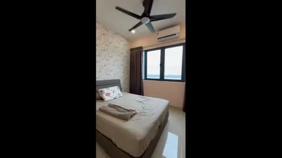 Bedroom features: queen-size bed, upholstered headboard, bedside pillow, ceiling fan, wall-mounted air conditioning unit, floor-to-ceiling window, curtains, decorative wall with floral pattern, tile flooring, light fixture, blanket on bed; style: modern; view: sea.