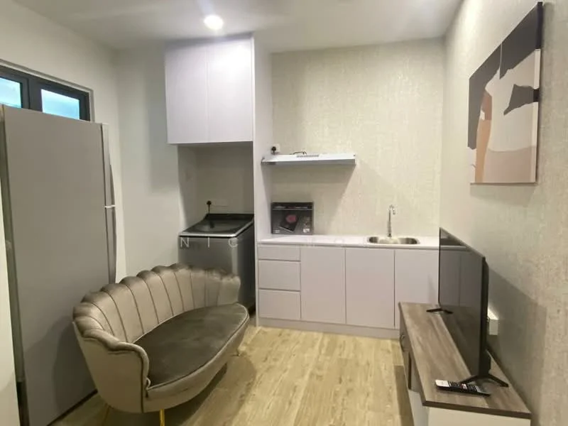 Living features: grey fabric sofa with curved design, wall-mounted TV, light wood flooring, white cabinetry, stainless-steel fridge, built-in washing machine, single-bowl stainless-steel sink, countertop with backsplash, recessed lighting, decorative wall art; style: modern.