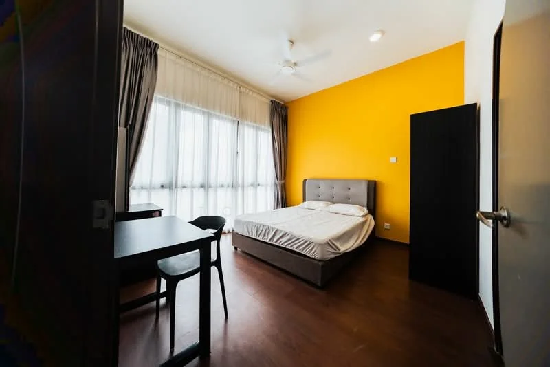 Bedroom features: queen-size bed with upholstered headboard, wooden flooring, yellow accent wall, white painted walls, floor-to-ceiling windows with sheer curtains, ceiling fan, study desk, black chair, black wardrobe; style: modern.